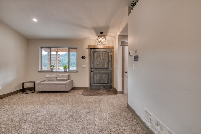 foyer with carpet flooring