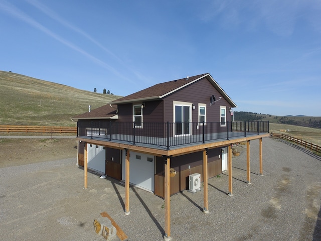 view of front of home featuring a deck, a rural view, and central AC unit