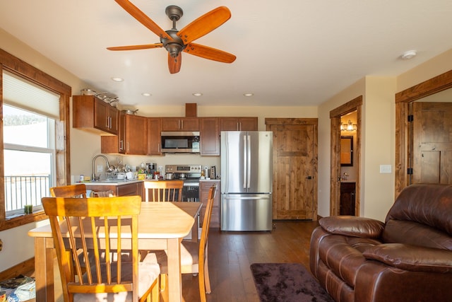 dining space featuring sink, dark hardwood / wood-style flooring, and ceiling fan