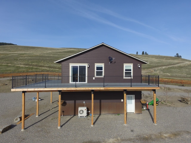 back of house featuring a deck and central AC