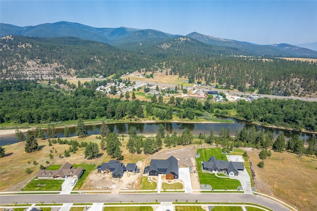 drone / aerial view featuring a water and mountain view