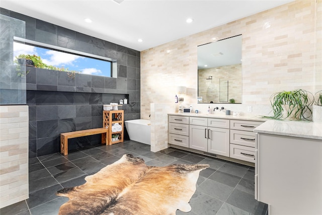 bathroom featuring shower with separate bathtub, tile walls, and vanity