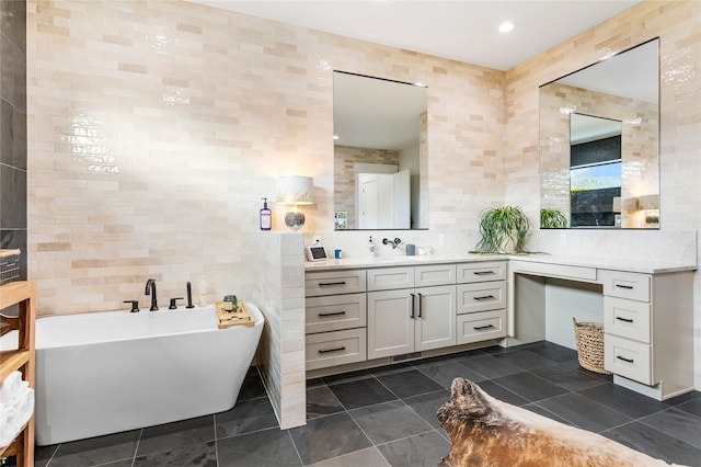 bathroom featuring tile walls, a washtub, and vanity