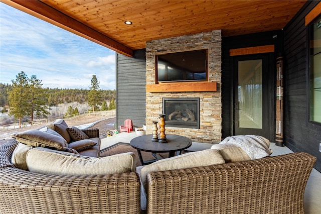 view of patio / terrace featuring an outdoor stone fireplace