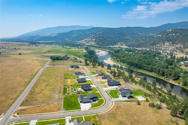 drone / aerial view featuring a water and mountain view