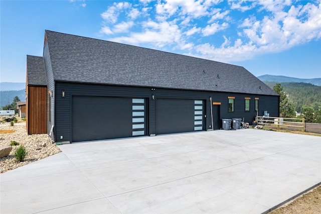 view of property exterior featuring a mountain view and a garage