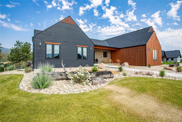 rear view of property featuring a patio area and a yard