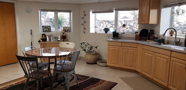 kitchen with sink and light tile floors