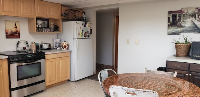 kitchen with light brown cabinetry, electric range, white fridge, and light tile floors