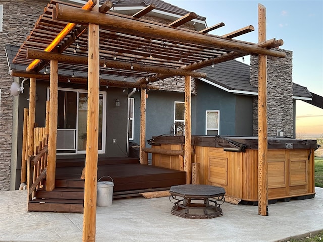 wooden deck with a pergola, a patio area, and a hot tub