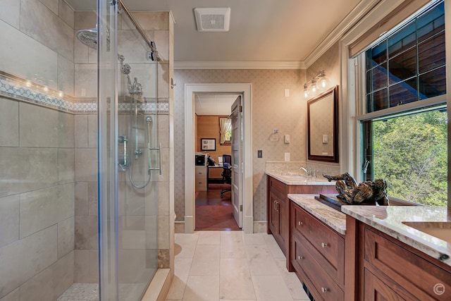 bathroom featuring ornamental molding, dual bowl vanity, a shower with shower door, and tile floors