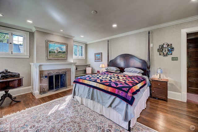 bedroom with crown molding and hardwood / wood-style flooring