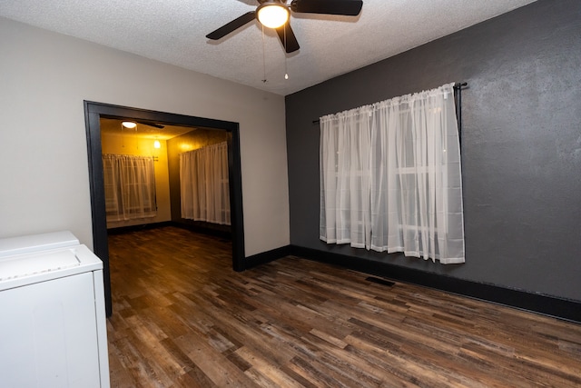 empty room featuring ceiling fan, dark hardwood / wood-style floors, and a textured ceiling