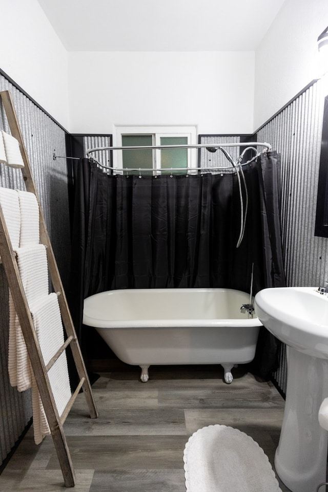 bathroom with hardwood / wood-style flooring and shower / bath combination with curtain