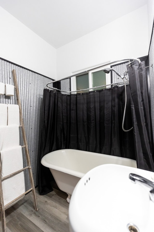 bathroom with sink, independent shower and bath, and wood-type flooring