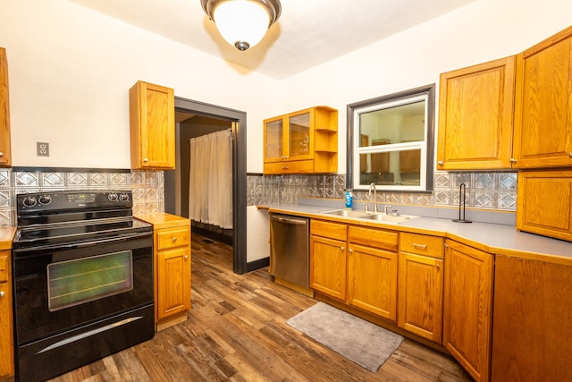 kitchen with dishwasher, hardwood / wood-style flooring, black / electric stove, sink, and decorative backsplash