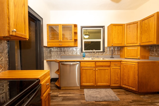 kitchen with dark wood-type flooring, tasteful backsplash, stainless steel dishwasher, and sink