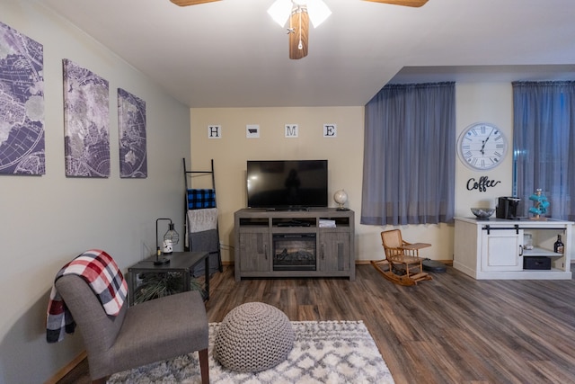 living room with ceiling fan and dark hardwood / wood-style floors