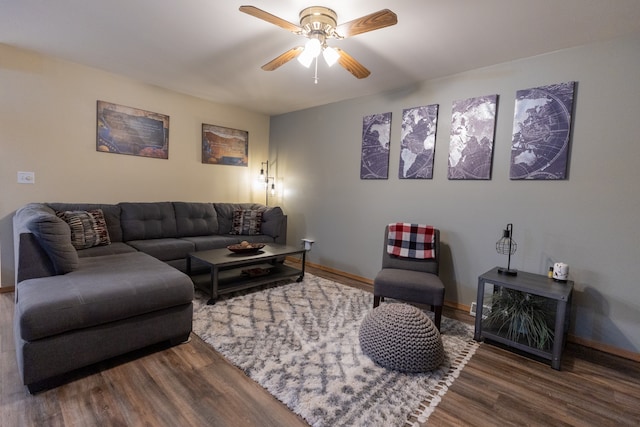 living room featuring ceiling fan and dark hardwood / wood-style floors