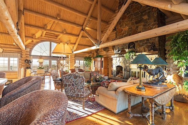 55263 Logan Rd, Charlo, MT 59824 - living area featuring high vaulted ceiling, wooden ceiling with exposed beams, rustic walls, plenty of natural light, and wood finished floors