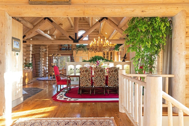 55263 Logan Rd, Charlo, MT 59824 - dining room featuring log walls, a chandelier, wood finished floors, and wooden ceiling