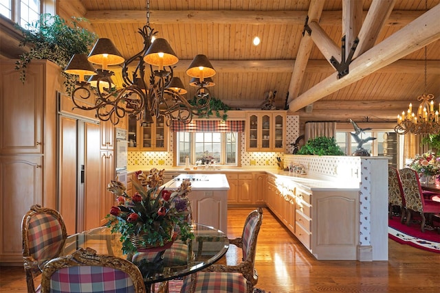55263 Logan Rd, Charlo, MT 59824 - kitchen with a chandelier, wood ceiling, light countertops, light wood-type flooring, and glass insert cabinets