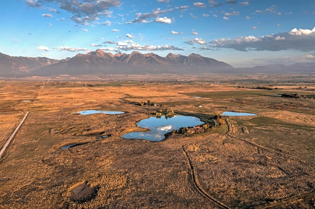 birds eye view of property with a water and mountain view