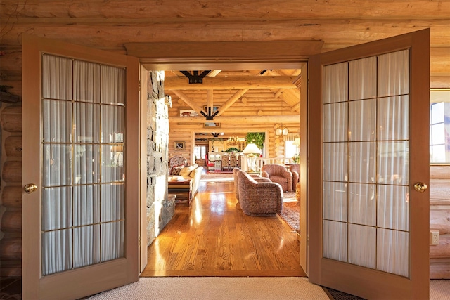 55263 Logan Rd, Charlo, MT 59824 - entryway featuring rustic walls, beamed ceiling, and wood finished floors