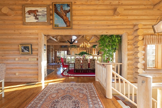 55263 Logan Rd, Charlo, MT 59824 - hall featuring rustic walls, wood-type flooring, and a chandelier