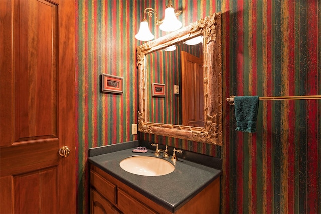 55263 Logan Rd, Charlo, MT 59824 - bathroom featuring vanity, wallpapered walls, and a chandelier