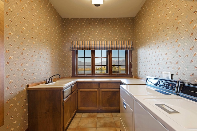 55263 Logan Rd, Charlo, MT 59824 - laundry room with washer and dryer, wallpapered walls, and cabinet space