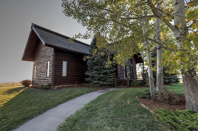 cabin with a front lawn