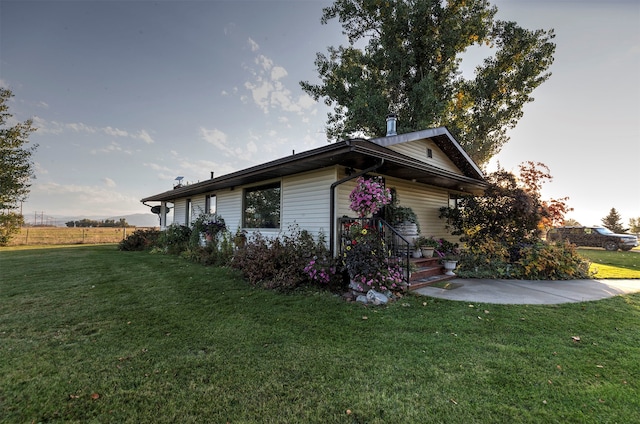 view of home's exterior with a yard