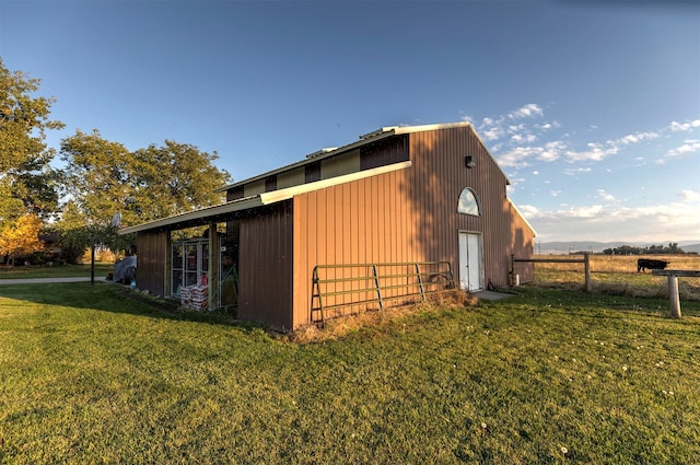 view of side of home with a lawn