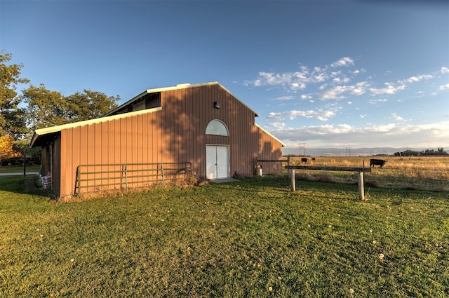 view of shed / structure with a rural view and a lawn