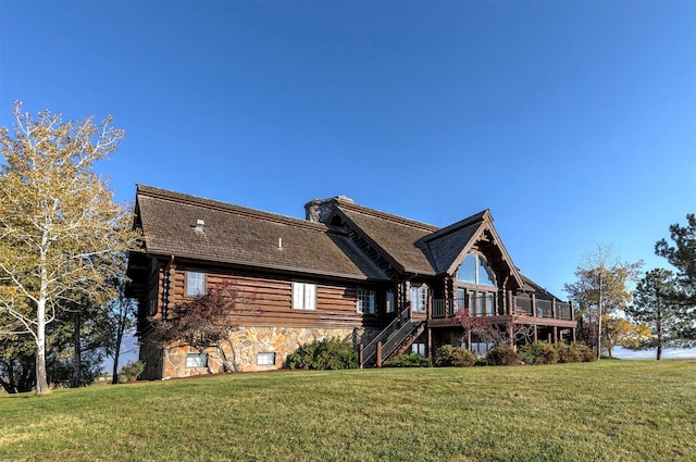 55263 Logan Rd, Charlo, MT 59824 - rear view of property with a yard, a deck, stairs, and stone siding