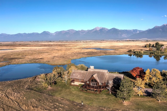 aerial view featuring a water and mountain view and a rural view