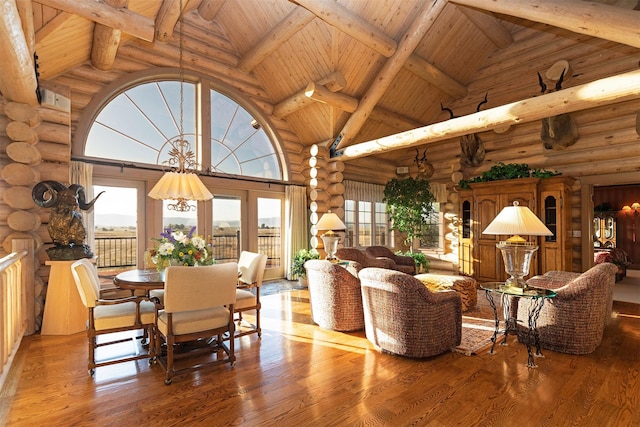 55263 Logan Rd, Charlo, MT 59824 - dining space with rustic walls, high vaulted ceiling, wood ceiling with exposed beams, and wood finished floors