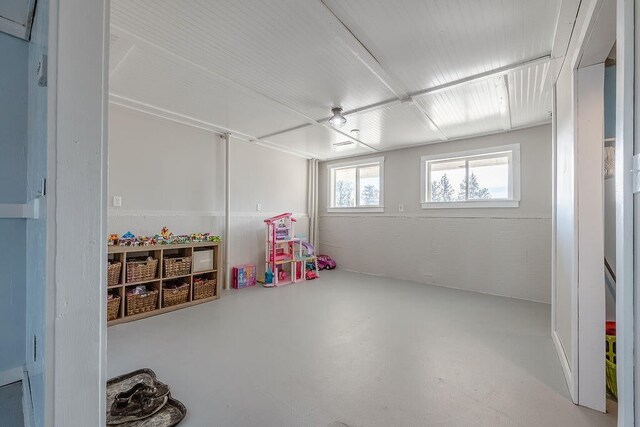 recreation room featuring concrete flooring