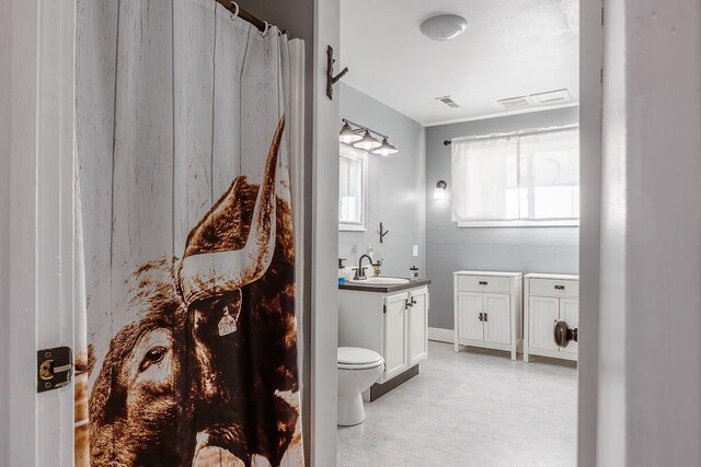 bathroom with tile patterned flooring, toilet, and vanity