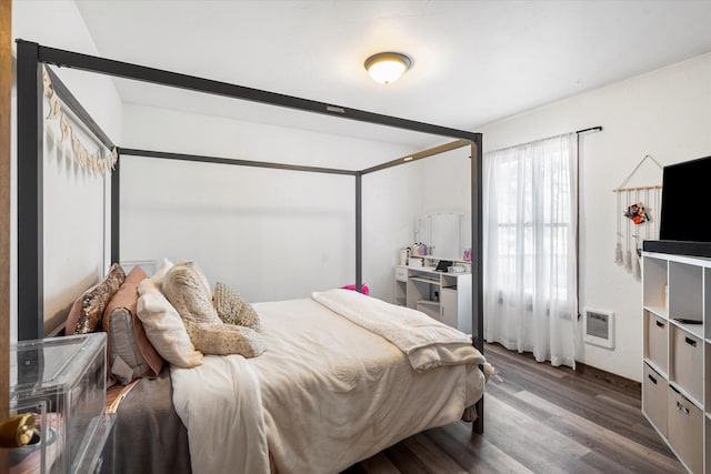 bedroom with dark hardwood / wood-style flooring