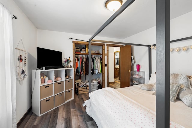 bedroom with dark wood-type flooring and a closet