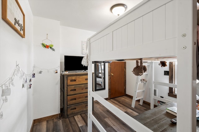 bedroom with dark wood-type flooring