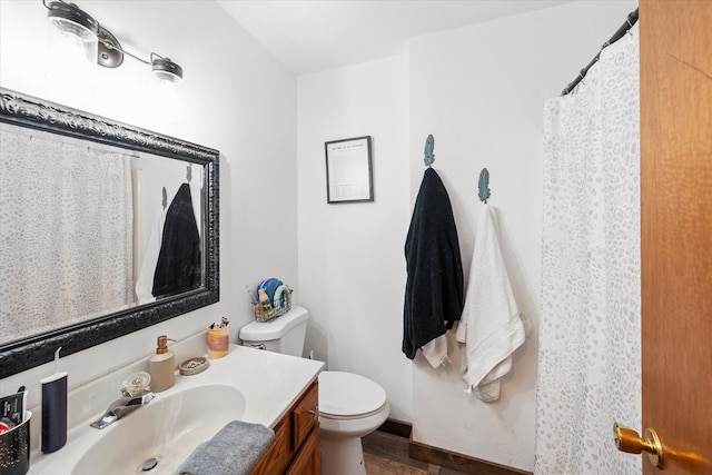 bathroom featuring toilet and vanity