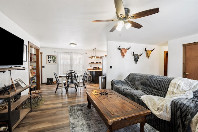 living room featuring ceiling fan and dark wood-type flooring