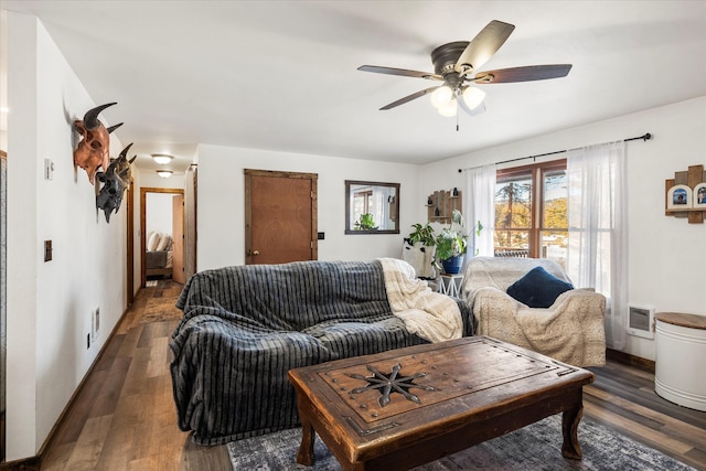 living room with dark hardwood / wood-style flooring and ceiling fan