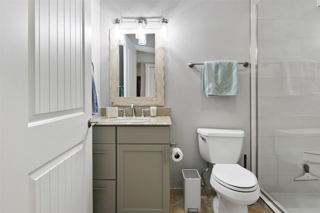 bathroom with tile floors, toilet, vanity, and an enclosed shower