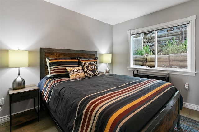 bedroom featuring multiple windows and dark wood-type flooring