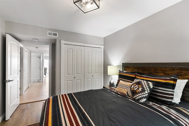 bedroom with a closet and light tile floors