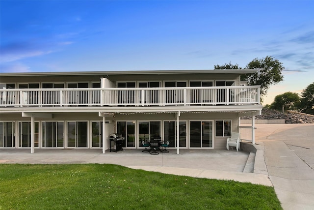 50300 US Highway 93 Unit B1/32, Polson, MT 59860 - rear view of property with a balcony, a patio area, and a lawn